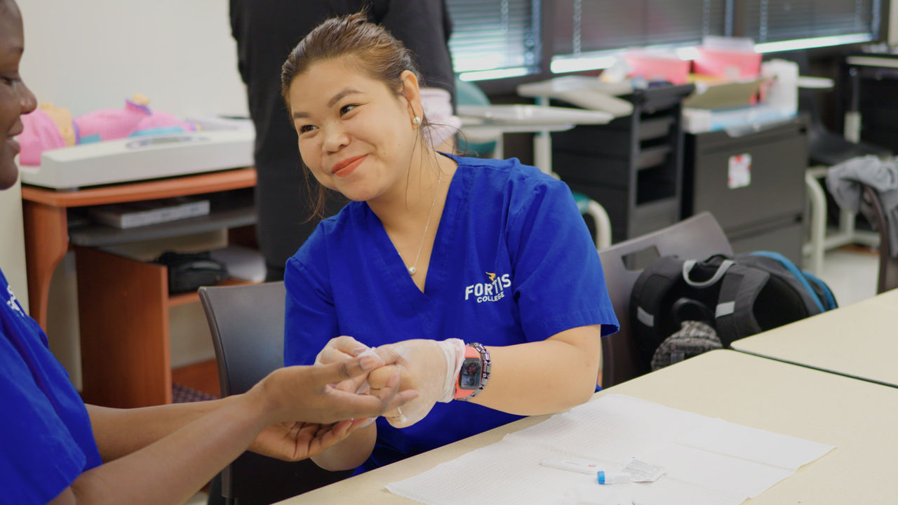 Nursing students practice clinical skills in classroom setting