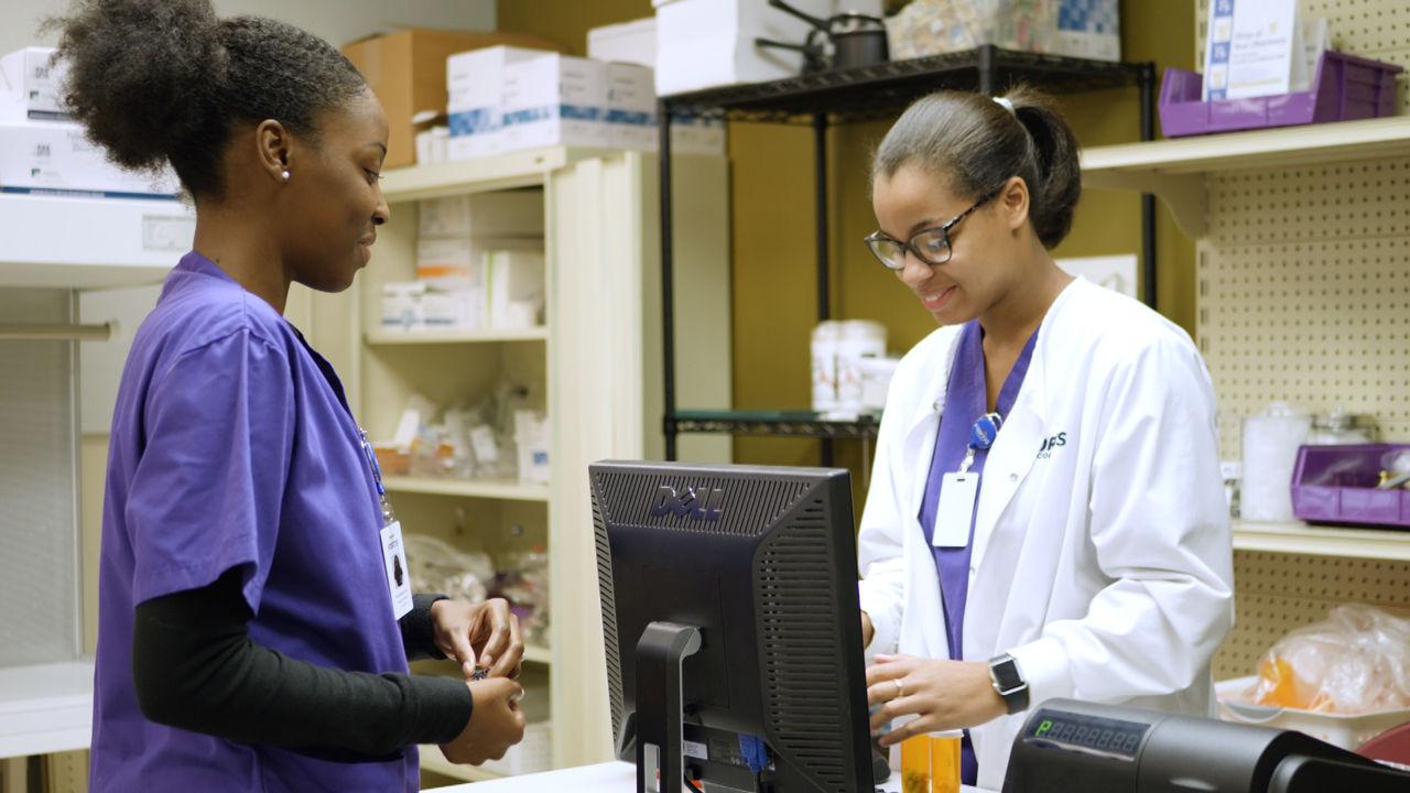 Healthcare Professionals Discuss in Medical Supply Room