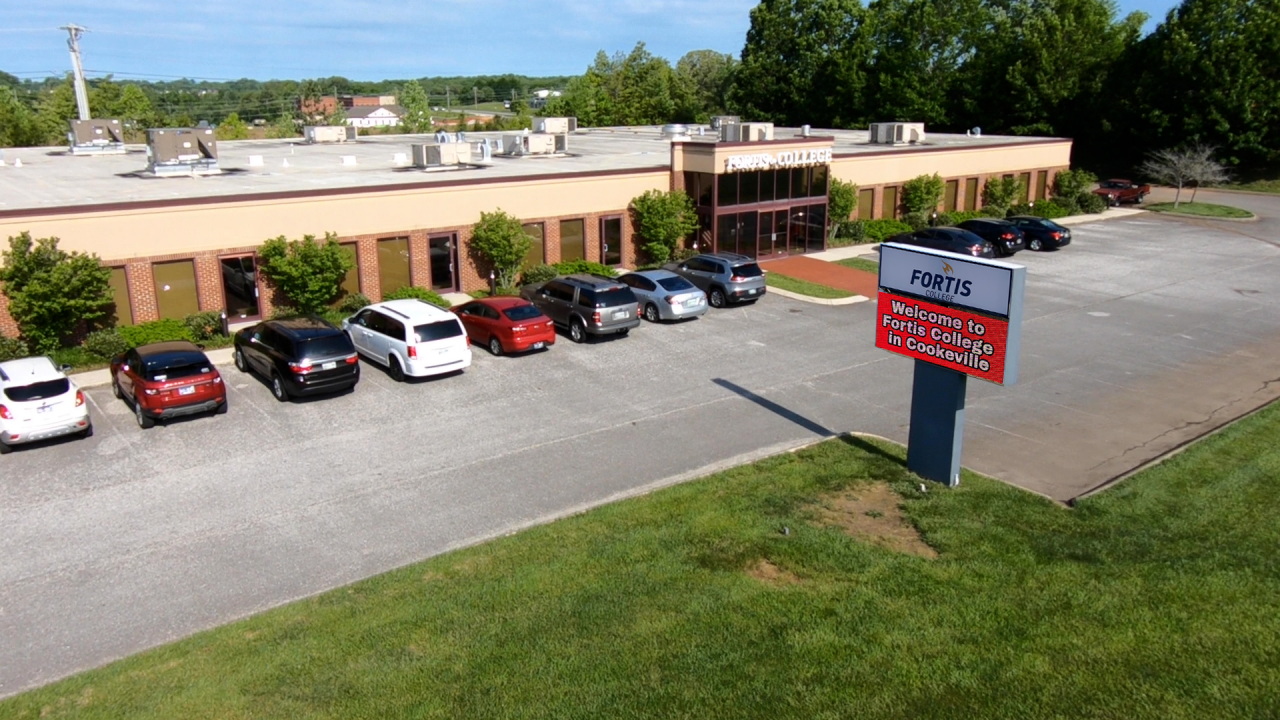 Fortis College exterior with parking lot and sign