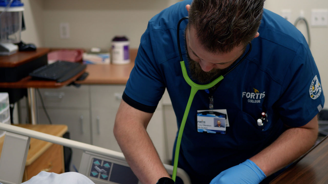 Healthcare professional examines patient in clinical setting