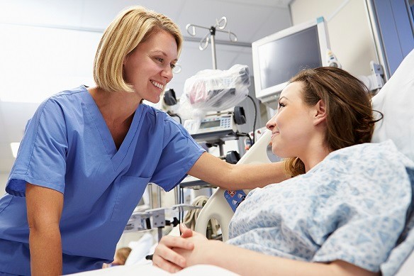 Young Female Patient Talking To Nurse In Emergency Room