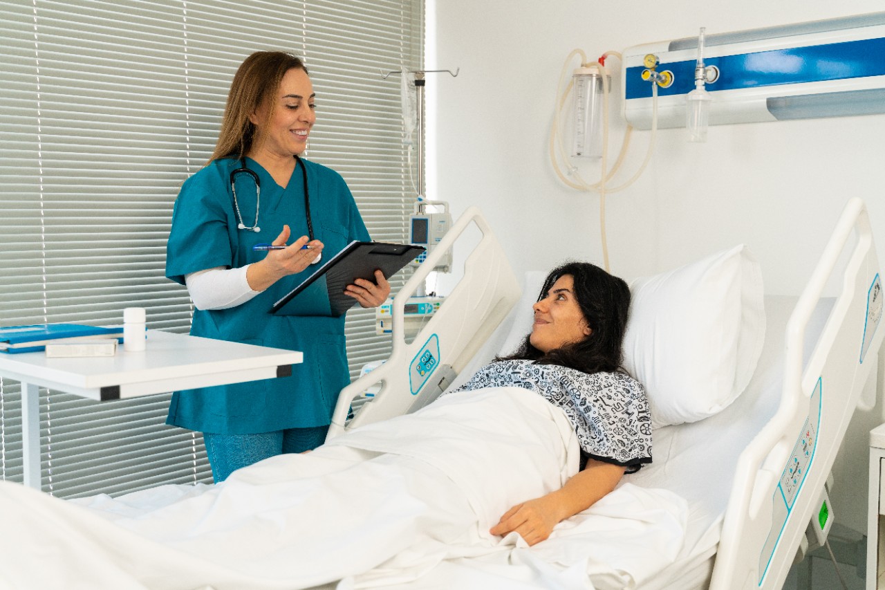 Female doctor and female patient talking in hospital