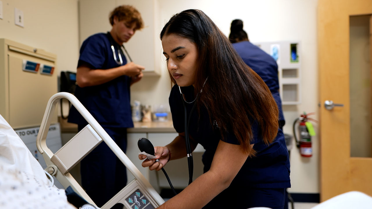 Healthcare professionals attending to patient in hospital room