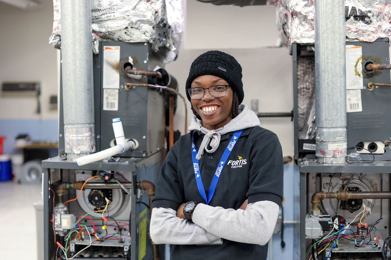 Technician standing between two open HVAC units