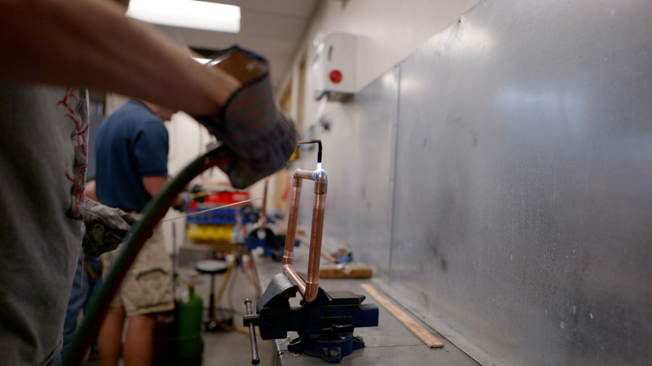Metalwork with Torch in Workshop Setting