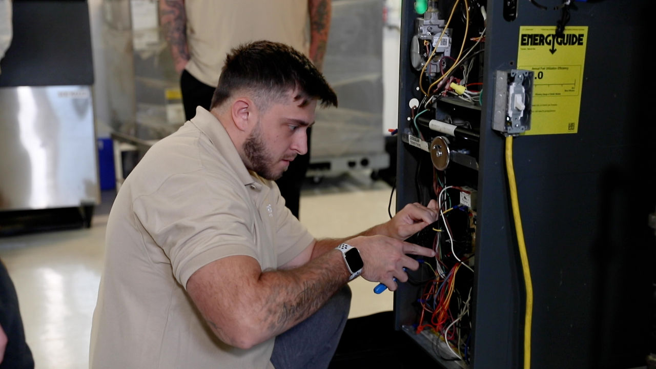 Technician repairing industrial equipment in workshop setting
