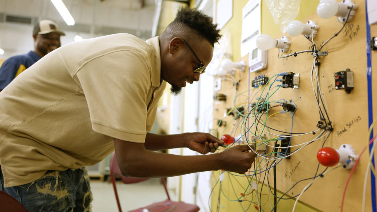 Student working on electrical wiring training board
