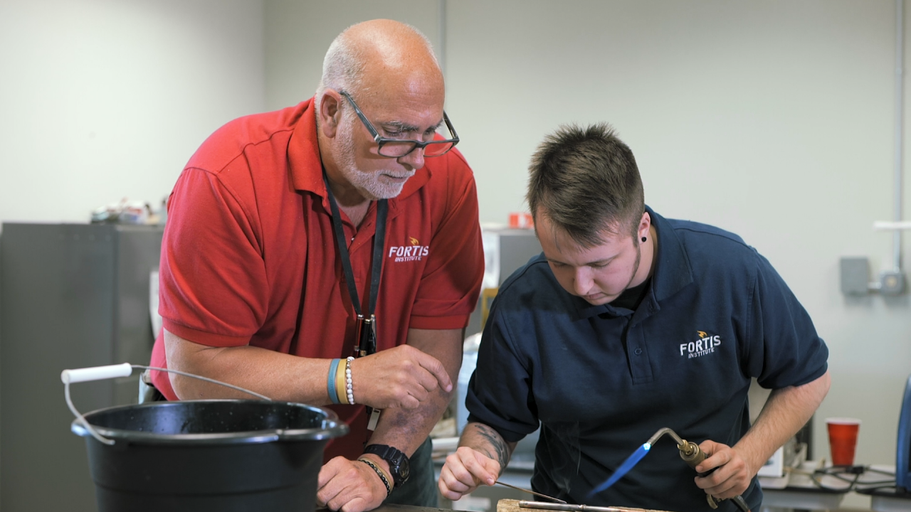 Technical training session with hands-on welding demonstration