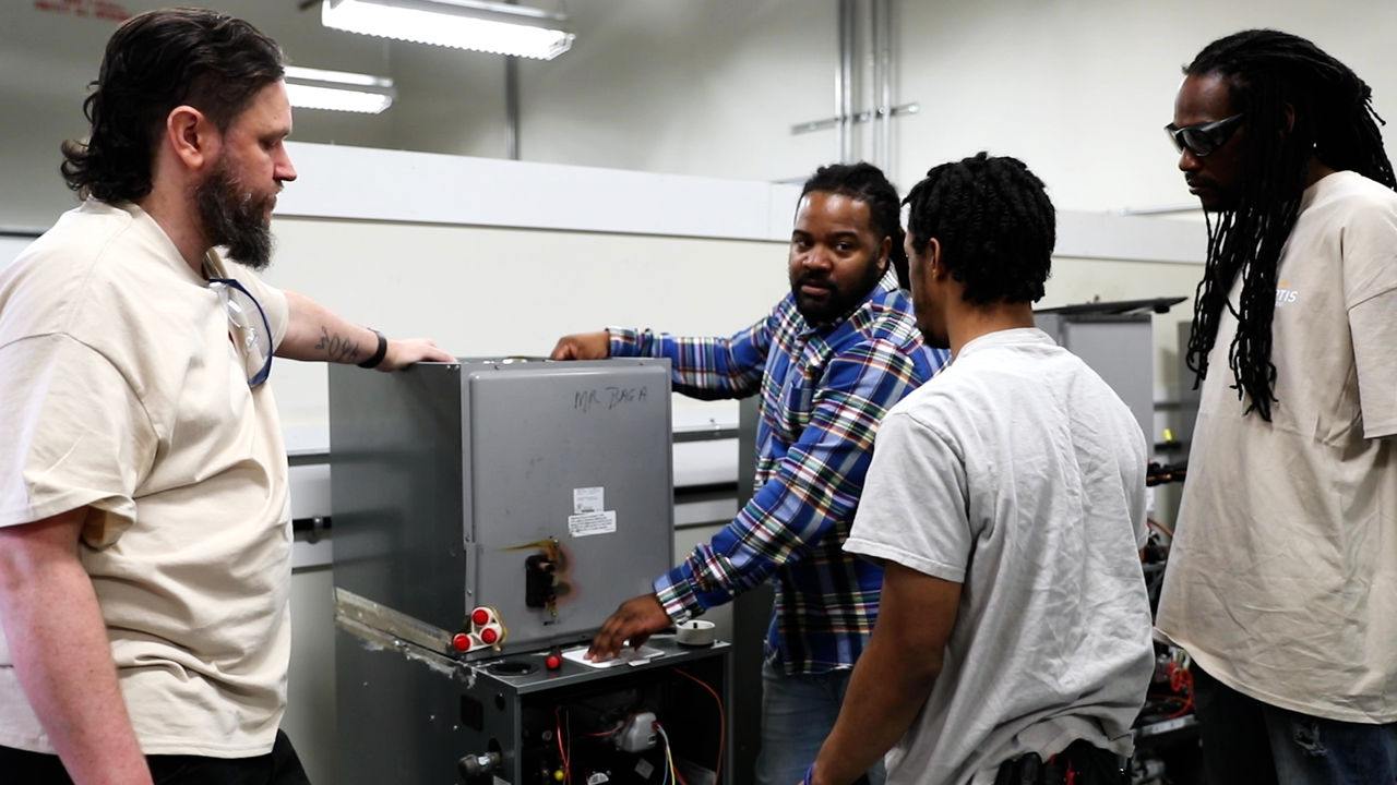 Group of technicians working on industrial equipment