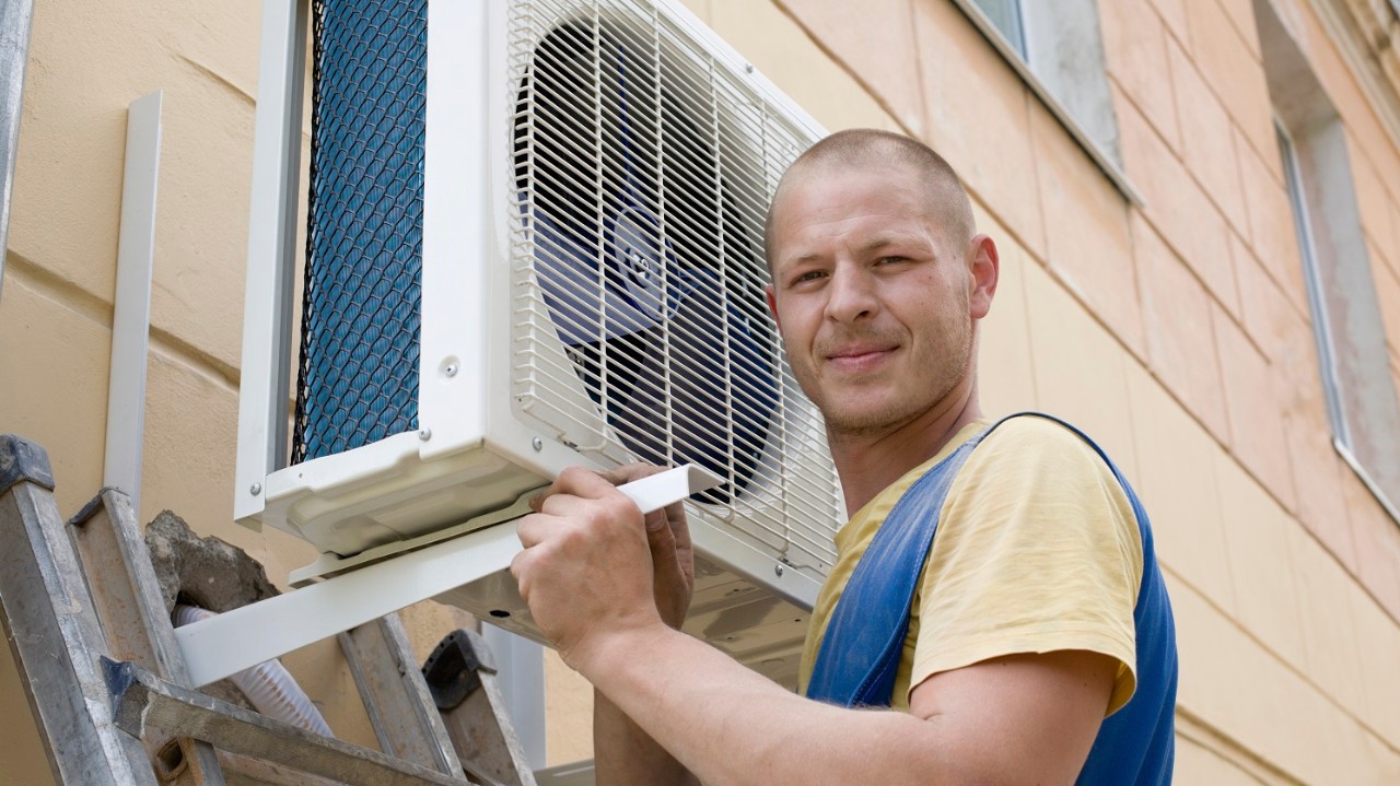 installer sets a new air conditioner