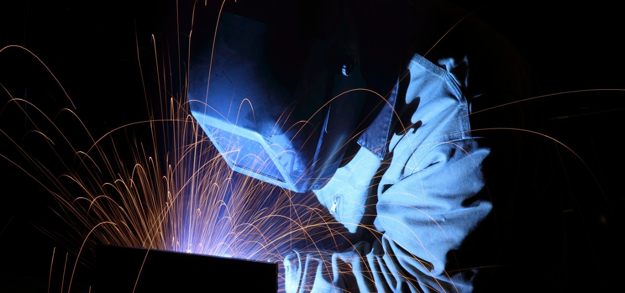 Welder working with sparks flying