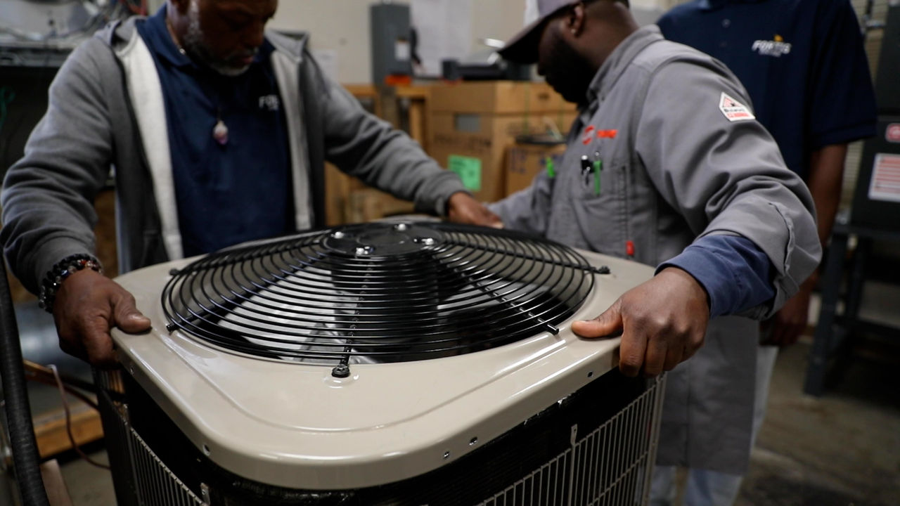 Technicians Installing Large Industrial Air Conditioning Unit
