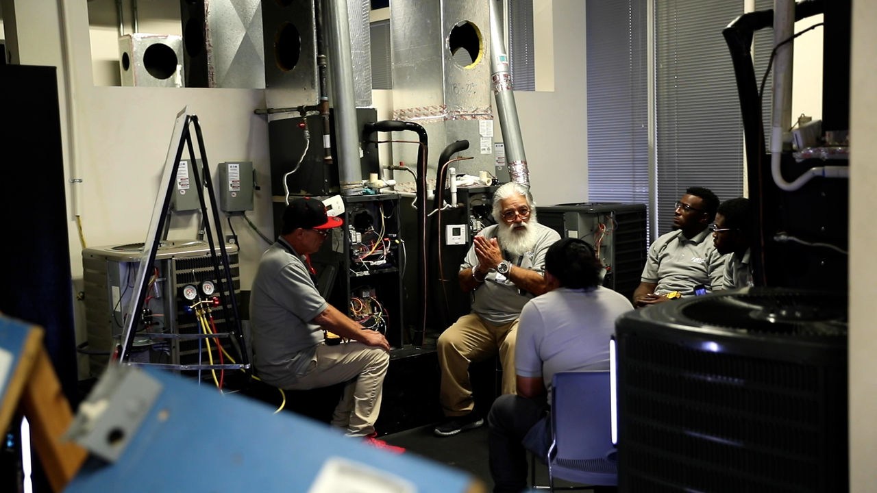 Group Training Session in HVAC Workshop Setting